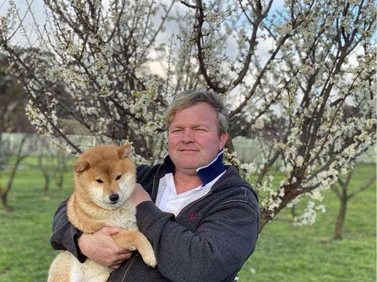 Cris and a Shiba Inu dog in his arms